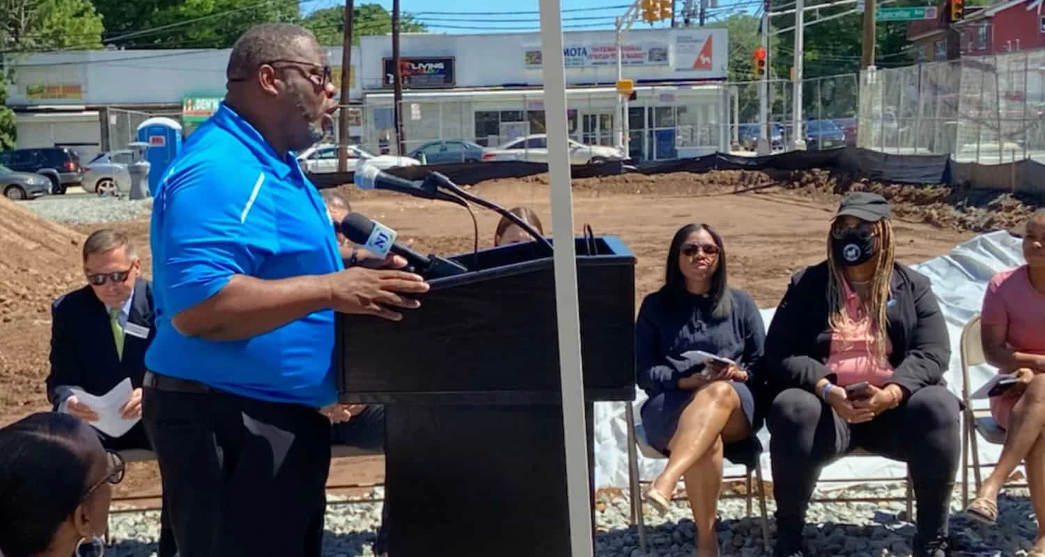 Tony Vauss speaking outdoors at an Irvington development site