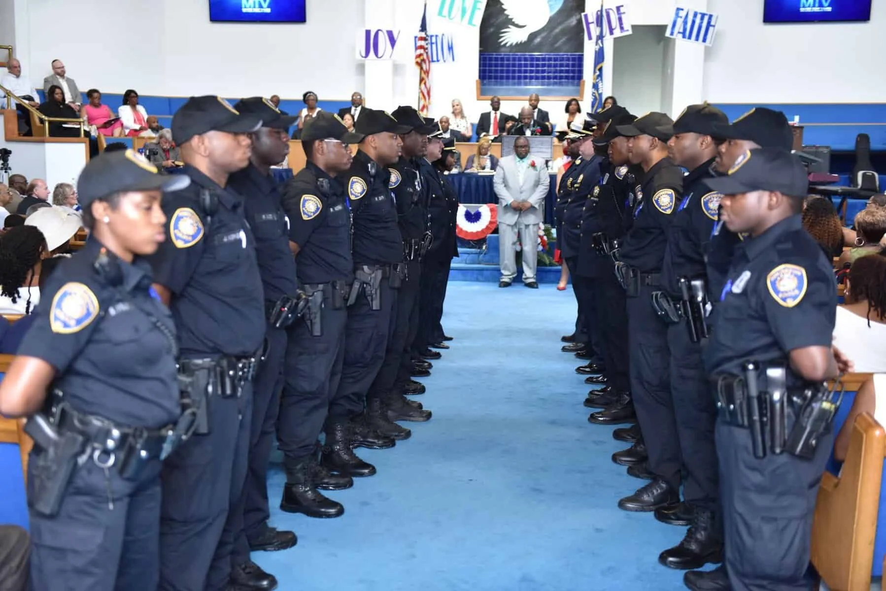 Irvington police officers standing in formation at an indoor ceremony