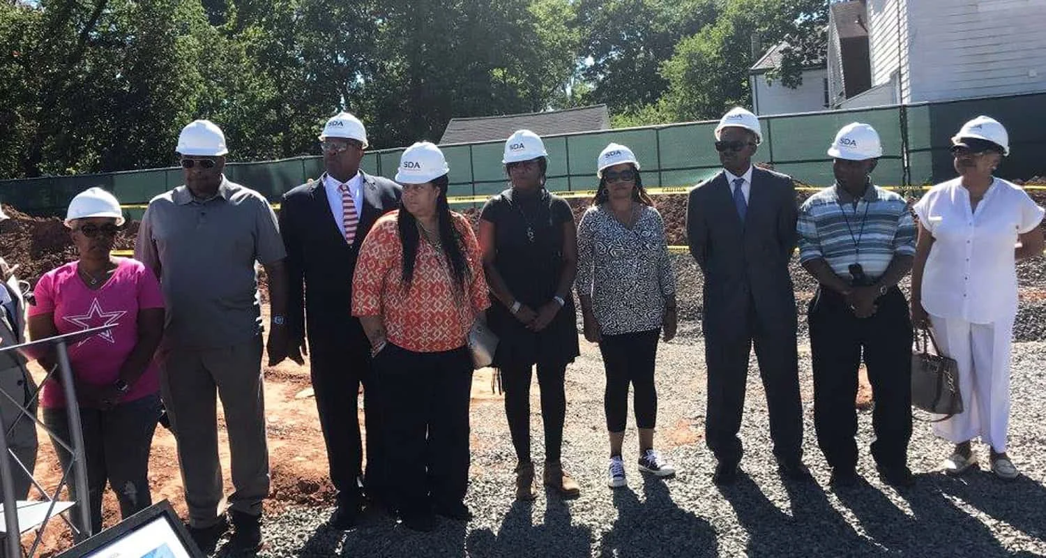 Community members at an Irvington redevelopment site