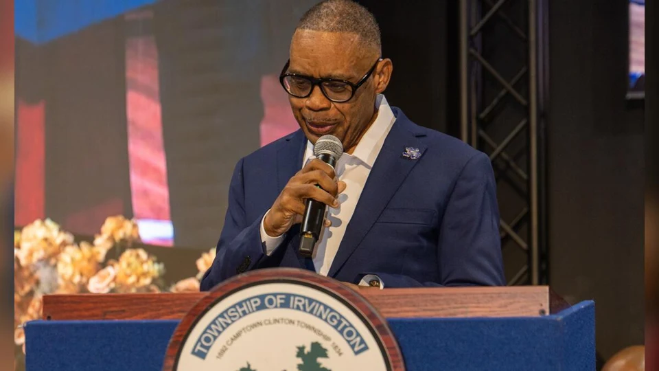 Tony Vauss speaking into a microphone at a podium