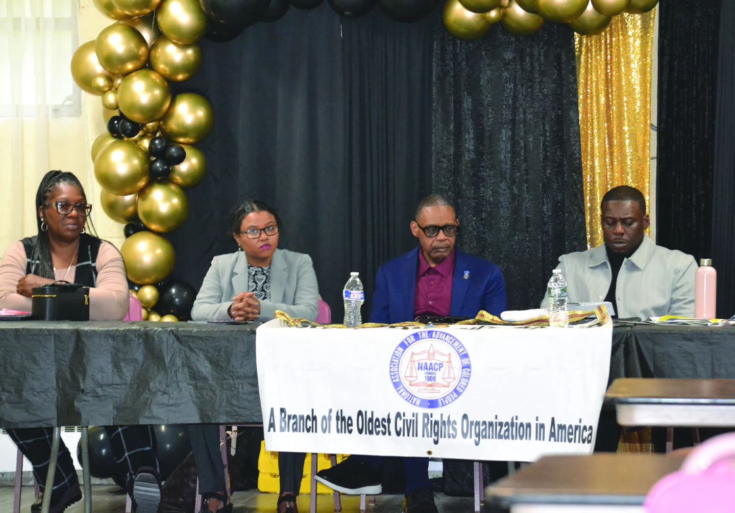 Tony Vauss and council colleagues seated at a candidates forum