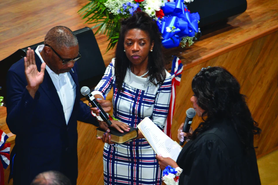 Tony Vauss taking the oath of office with family and an officiant